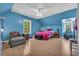 Spacious blue bedroom with laminate floors and lots of natural light coming in from two windows at 6357 Highway 707, Myrtle Beach, SC 29588