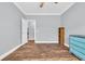 An empty bedroom with wood floors, a ceiling fan and an open door with trim at 6357 Highway 707, Myrtle Beach, SC 29588