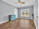Bedroom featuring light gray walls, wood-look floors, and natural light from large windows at 6357 Highway 707, Myrtle Beach, SC 29588