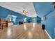 Spacious blue bonus room with hardwood floors, a piano and multiple windows at 6357 Highway 707, Myrtle Beach, SC 29588