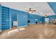 Large blue bonus room featuring an open layout with laminate floors, sink, and shelving at 6357 Highway 707, Myrtle Beach, SC 29588