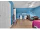 Blue bonus room with hardwood floors, a chair, a mini fridge and lots of open space at 6357 Highway 707, Myrtle Beach, SC 29588