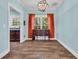 Dining room with natural light, wood floors, and an antique buffet with orange curtains at 6357 Highway 707, Myrtle Beach, SC 29588