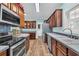 A kitchen featuring stainless steel appliances, wood cabinets, and a view of the laundry room at 6357 Highway 707, Myrtle Beach, SC 29588