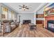 Inviting living room featuring wood floors, a fireplace, and a ceiling fan for comfort at 6357 Highway 707, Myrtle Beach, SC 29588