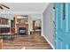 Open-concept living room with a cozy fireplace, wood flooring, and views into other rooms at 6357 Highway 707, Myrtle Beach, SC 29588