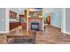 Living room with a fireplace, open layout, and wood floors adjacent to kitchen and dining areas at 6357 Highway 707, Myrtle Beach, SC 29588