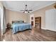 Main bedroom with wood-look floors, ceiling fan, and a view to an adjacent room at 6357 Highway 707, Myrtle Beach, SC 29588