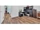 Office features a black desk, laminate floors and a view into a kitchen area at 6357 Highway 707, Myrtle Beach, SC 29588