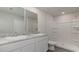 Bright bathroom featuring a double sink vanity, stone countertops, and a tiled shower at 647 Culmen Ct., Myrtle Beach, SC 29588