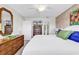 Inviting bedroom featuring a queen bed, bright white walls, a wooden dresser and ensuite bathroom at 66 Lakeview Circle # 106, Pawleys Island, SC 29585