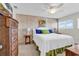 Inviting bedroom featuring a queen bed, bright white walls and a large wooden dresser at 66 Lakeview Circle # 106, Pawleys Island, SC 29585
