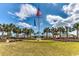 Beautiful clubhouse featuring vibrant landscaping, complemented by majestic palms and clear blue skies at 66 Lakeview Circle # 106, Pawleys Island, SC 29585