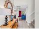 Bright entryway featuring tile flooring, staircase, console table, and seamless access to the living space at 66 Lakeview Circle # 106, Pawleys Island, SC 29585