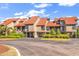 Stunning exterior view of elevated townhomes with mature landscaping and ample parking spaces at 66 Lakeview Circle # 106, Pawleys Island, SC 29585
