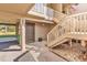 Exterior view of entryway featuring covered parking, stairs to the main entrance, and mature trees at 66 Lakeview Circle # 106, Pawleys Island, SC 29585