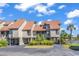 Beautiful exterior of this townhome featuring manicured landscaping and ample parking with water views at 66 Lakeview Circle # 106, Pawleys Island, SC 29585