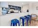 Modern kitchen featuring navy cabinets, stainless steel appliances, and a breakfast bar with seating at 66 Lakeview Circle # 106, Pawleys Island, SC 29585