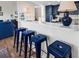 Open kitchen featuring blue cabinets, four counter stools, and bright white countertops at 66 Lakeview Circle # 106, Pawleys Island, SC 29585