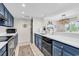 Modern kitchen with stylish blue cabinets, stainless steel appliances, and bright white countertops at 66 Lakeview Circle # 106, Pawleys Island, SC 29585