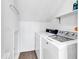Efficient laundry room featuring a stacked washer and dryer and overhead storage shelf at 66 Lakeview Circle # 106, Pawleys Island, SC 29585