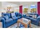 Inviting living room with comfortable blue couches, stylish decor, and sliding doors to a balcony at 66 Lakeview Circle # 106, Pawleys Island, SC 29585