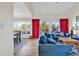 Bright living room featuring comfortable couches, a dining table and sliding doors to a balcony at 66 Lakeview Circle # 106, Pawleys Island, SC 29585