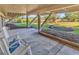 Relaxing outdoor patio with rocking chairs, a hammock, and views of lush landscaping at 66 Lakeview Circle # 106, Pawleys Island, SC 29585