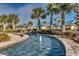 Elegant water feature enhances the clubhouse's aesthetic, framed by swaying palms under a sunny sky at 66 Lakeview Circle # 106, Pawleys Island, SC 29585