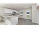 Bright kitchen with white cabinets, stainless appliances, and an island with a sink at 663 Culmen Ct., Myrtle Beach, SC 29588
