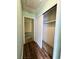 Hallway with hardwood floors and closet space, offering a transition between living areas at 6638 Greenslake Point, Myrtle Beach, SC 29588