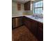 A kitchen featuring wood cabinets, a stainless steel dishwasher, and a double-basin sink under a window at 6638 Greenslake Point, Myrtle Beach, SC 29588
