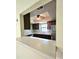 Kitchen pass-through view with wood cabinets, stainless steel refrigerator, and sink area at 6638 Greenslake Point, Myrtle Beach, SC 29588