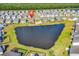 Drone shot of a residential community nestled around a pond, marked with a pinpoint location at 684 Wailea Circle, Little River, SC 29566