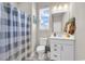Bright bathroom featuring a vanity, mirror, and shower with a patterned curtain at 684 Wailea Circle, Little River, SC 29566