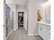 Well-lit bathroom with patterned tile floor, shower with glass door, and walk-in closet at 684 Wailea Circle, Little River, SC 29566