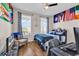 Inviting bedroom featuring hardwood floors, blue accents, flags, and a ceiling fan at 684 Wailea Circle, Little River, SC 29566