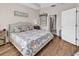 Cozy bedroom featuring hardwood floors, neutral walls, and a bed dressed in floral bedding at 684 Wailea Circle, Little River, SC 29566