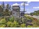 The entrance to the Sunset Landing community shows lush landscaping and stone features at 684 Wailea Circle, Little River, SC 29566
