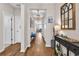 Inviting hallway features stylish decor, elegant lighting, and wood flooring leading to various rooms of the home at 684 Wailea Circle, Little River, SC 29566