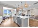 Open-concept kitchen with a large island, stainless steel appliances, and views of the dining and living areas at 684 Wailea Circle, Little River, SC 29566
