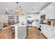 Bright kitchen with stainless steel appliances, a gray island, and an open view to the living area at 684 Wailea Circle, Little River, SC 29566