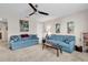 Cozy living room with plush sofas, beach-themed artwork, ceiling fan, and neutral carpet for relaxed living at 684 Wailea Circle, Little River, SC 29566