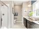 Modern bathroom with a glass enclosed shower, double vanity, and decorative art at 7075 Denim Loop, Myrtle Beach, SC 29579