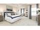 Spacious main bedroom featuring a tray ceiling, large windows, and a luxurious en-suite bathroom at 7075 Denim Loop, Myrtle Beach, SC 29579