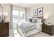 Bright bedroom with blue and white patterned bedding and curtains, and two side tables at 7075 Denim Loop, Myrtle Beach, SC 29579
