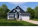 Charming two-story home with a blue exterior, white trim, and a well-manicured lawn on a sunny day at 7075 Denim Loop, Myrtle Beach, SC 29579