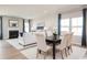Open-concept living and dining area featuring a fireplace, hardwood floors, and abundant natural light at 7075 Denim Loop, Myrtle Beach, SC 29579