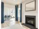 Cozy living room features a fireplace, hardwood floors, and a sliding glass door leading to an outdoor patio at 7075 Denim Loop, Myrtle Beach, SC 29579