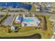 Aerial view of a resort style pool area with a clubhouse, surrounded by a lake and residential community at 732 Mustang Ranch Dr., Myrtle Beach, SC 29588